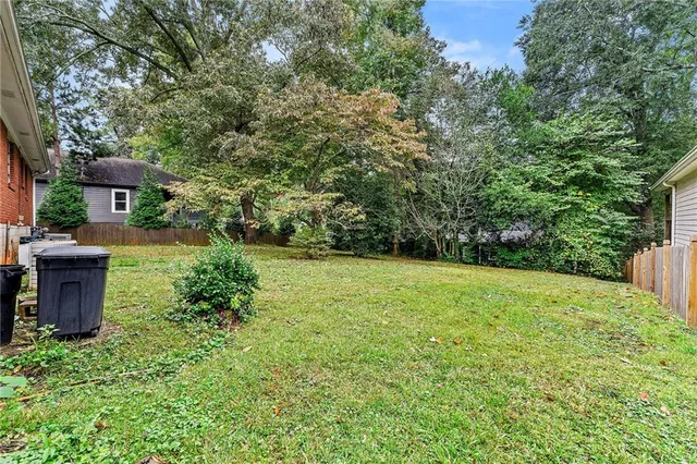 a view of a garden with large trees