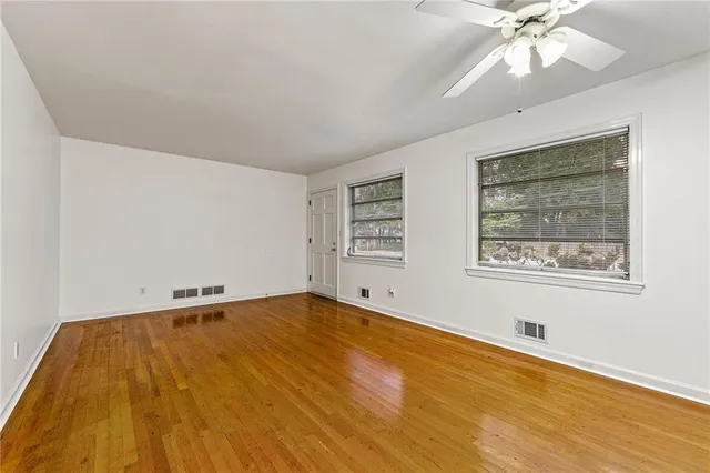 wooden floor in an empty room with a window
