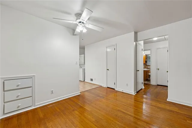 a view of an empty room with wooden floor