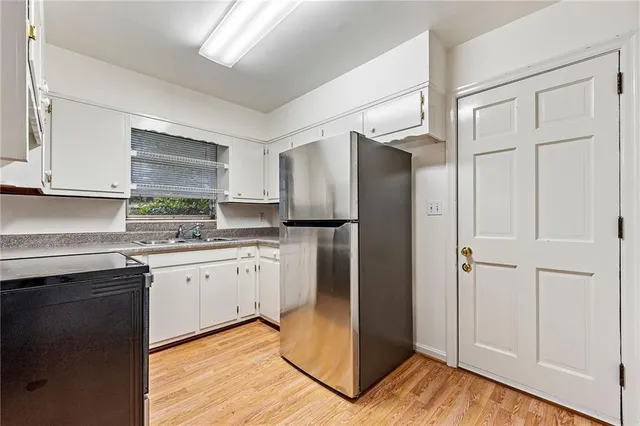 a kitchen with granite countertop cabinets appliances and a counter space