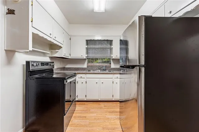 a kitchen with stainless steel appliances granite countertop a refrigerator and a stove