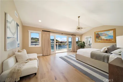 a bedroom with furniture and a large window