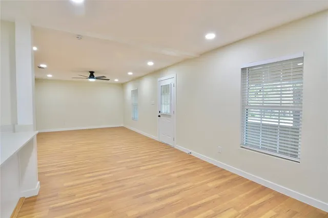 a view of an empty room with a ceiling fan