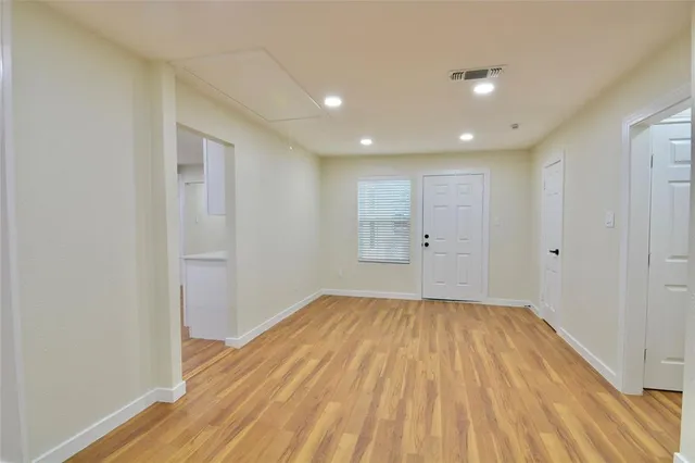 a view of an empty room with a ceiling fan