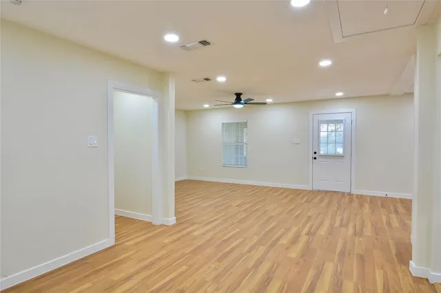 a view of empty room with wooden floor