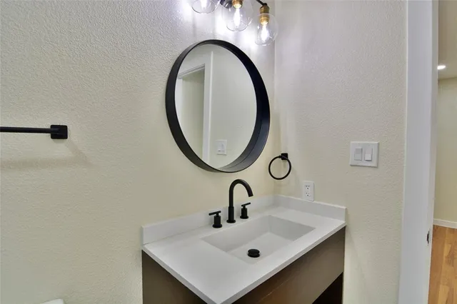 a bathroom with a sink a toilet and a mirror