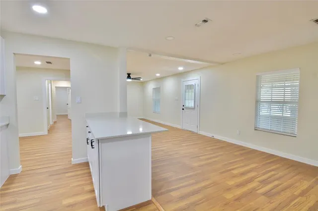 a view of kitchen with kitchen island wooden cabinets and stainless steel appliances