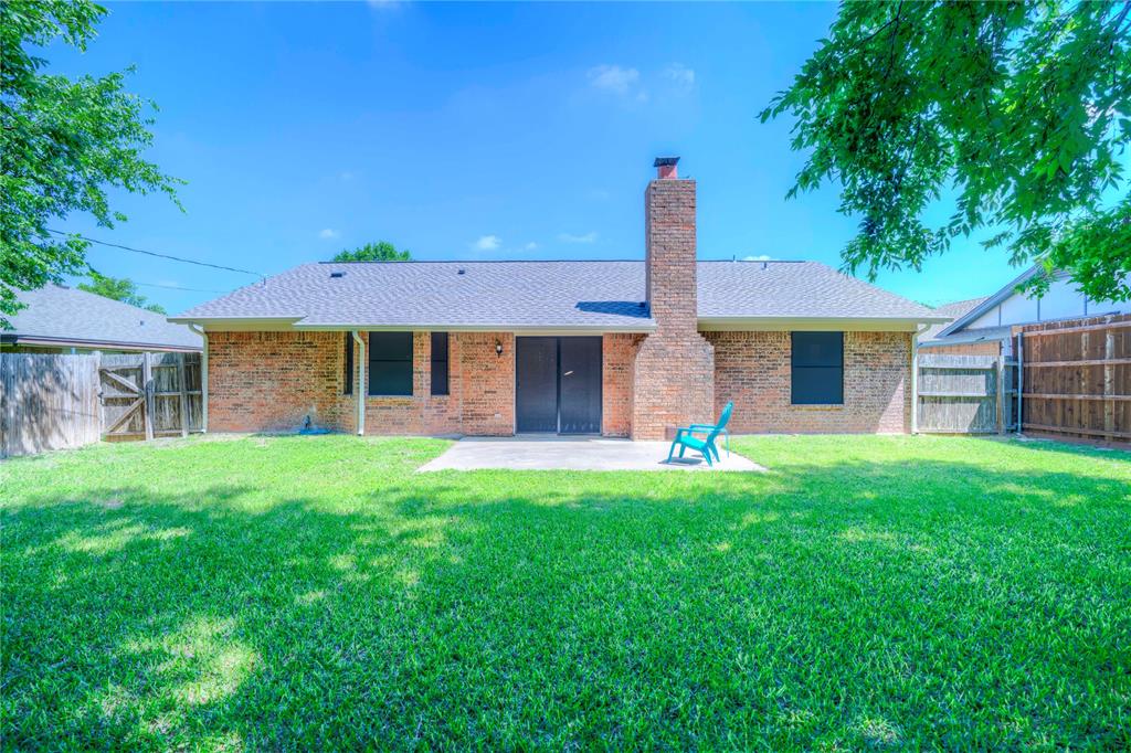 6028 Ridgecrest Drive Watauga, TX 76148 - Photo 34 of 40 a front view of a house with a yard and garage