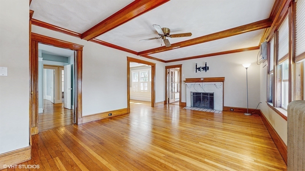 68 Bradford Road Watertown, MA 02472 - Photo 13 of 42 a view of an empty room with wooden floor fireplace and a window