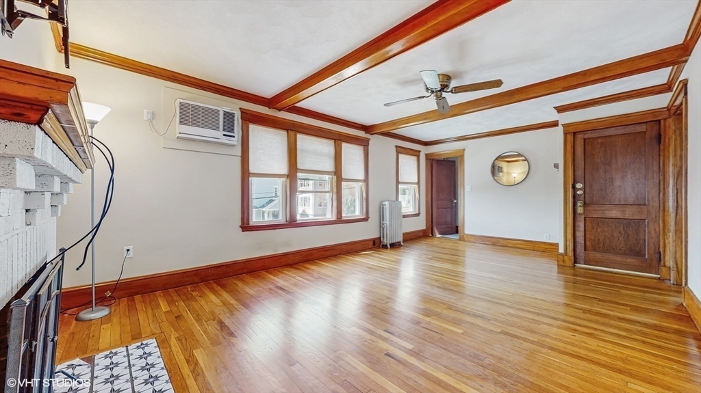 68 Bradford Road Watertown, MA 02472 - Photo 14 of 42 a view of an empty room with wooden floor and a window