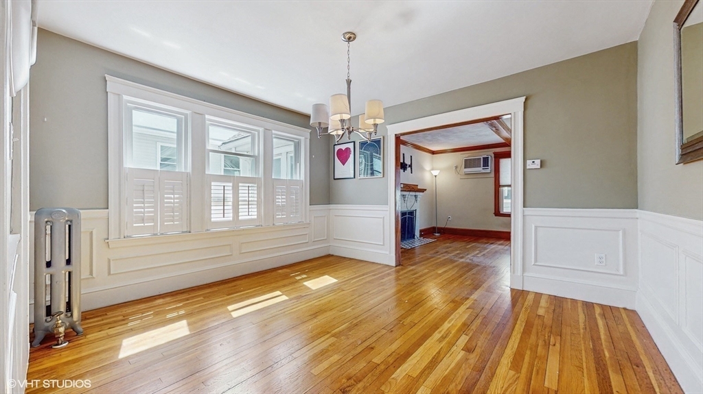 68 Bradford Road Watertown, MA 02472 - Photo 19 of 42 a view of a hallway with wooden floor and chandelier