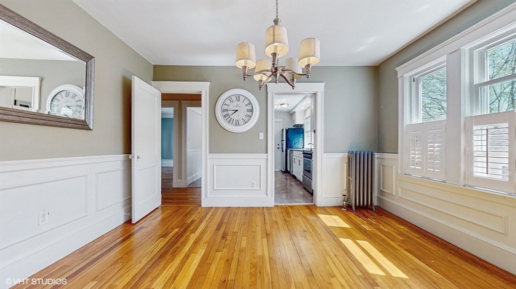 68 Bradford Road Watertown, MA 02472 - Photo 21 of 42 a view of a hallway with wooden floor and a window