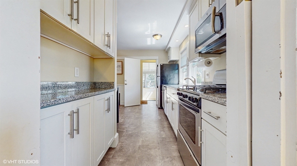 68 Bradford Road Watertown, MA 02472 - Photo 23 of 42 a kitchen with white cabinets and stainless steel appliances