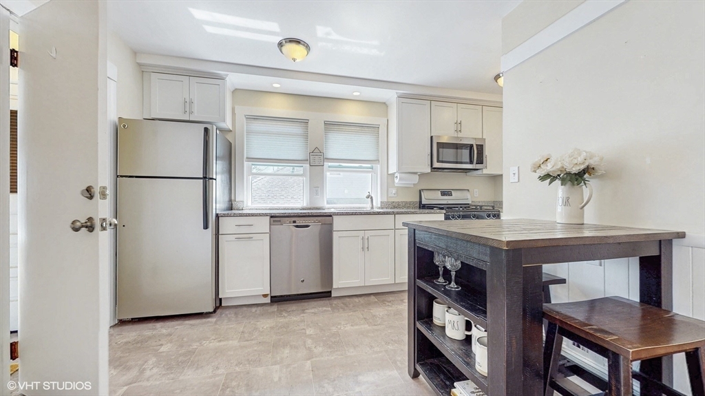 68 Bradford Road Watertown, MA 02472 - Photo 25 of 42 a kitchen with a sink cabinets and stainless steel appliances