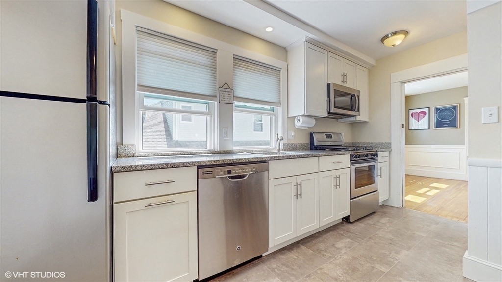 68 Bradford Road Watertown, MA 02472 - Photo 26 of 42 a kitchen with white cabinets and white appliances
