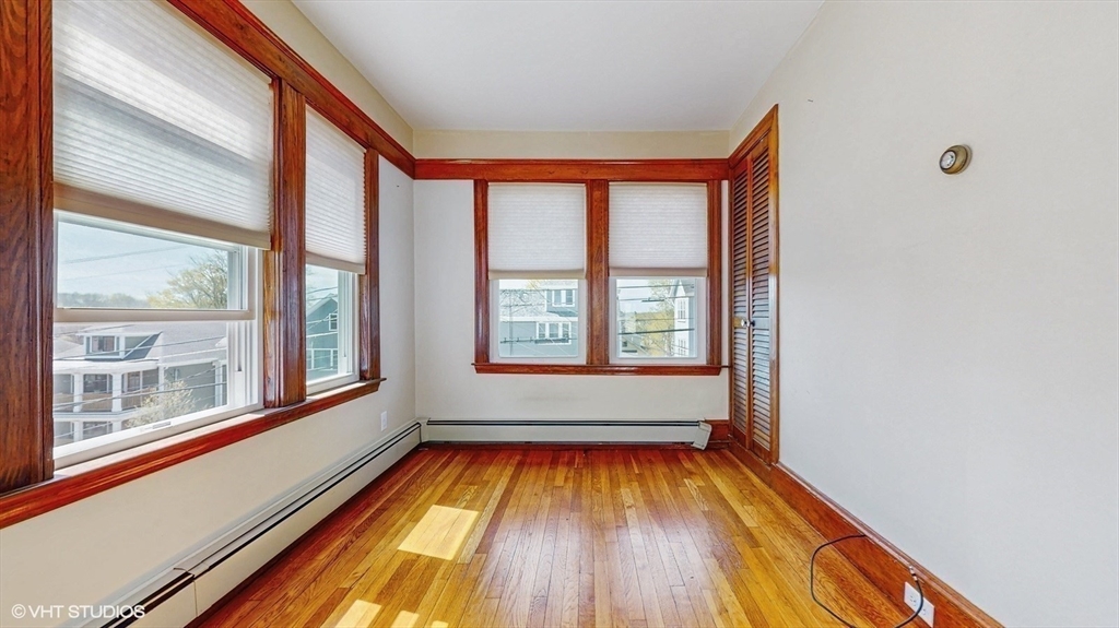 68 Bradford Road Watertown, MA 02472 - Photo 28 of 42 a view of an empty room with a window and wooden floor