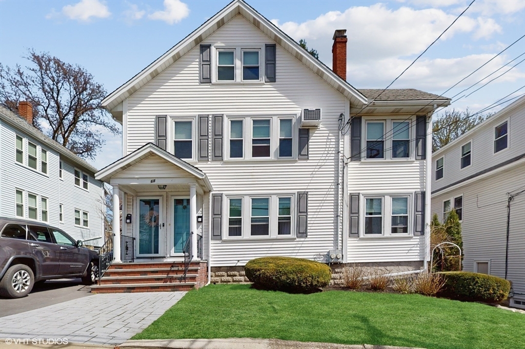 68 Bradford Road Watertown, MA 02472 - Photo 3 of 42 a front view of a house with a yard