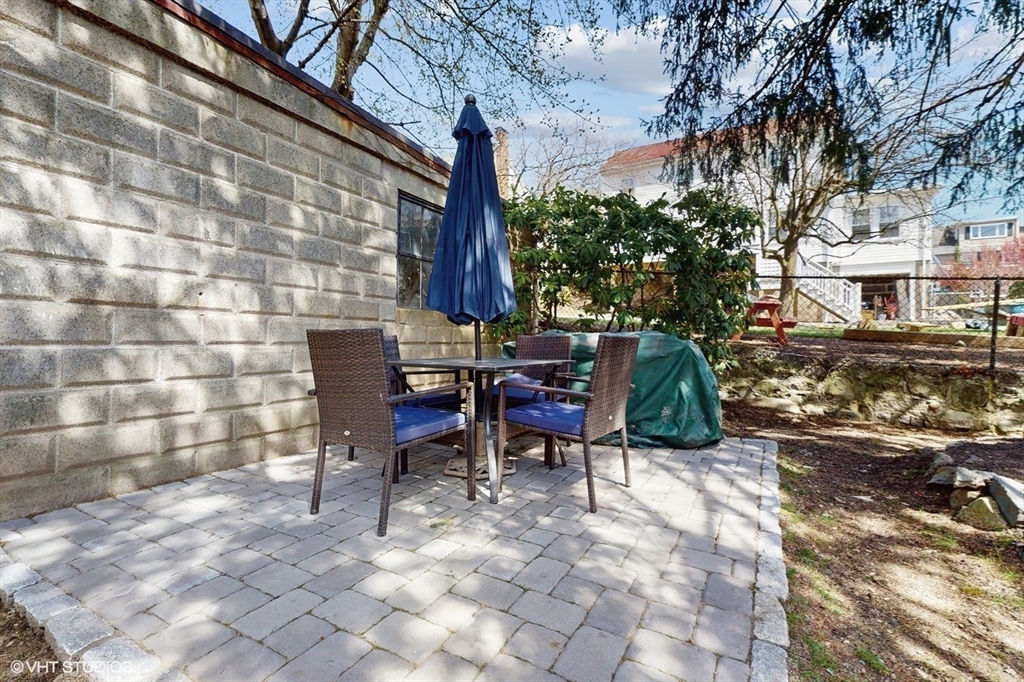 68 Bradford Road Watertown, MA 02472 - Photo 8 of 42 a view of a chairs and tables in the back yard of the house