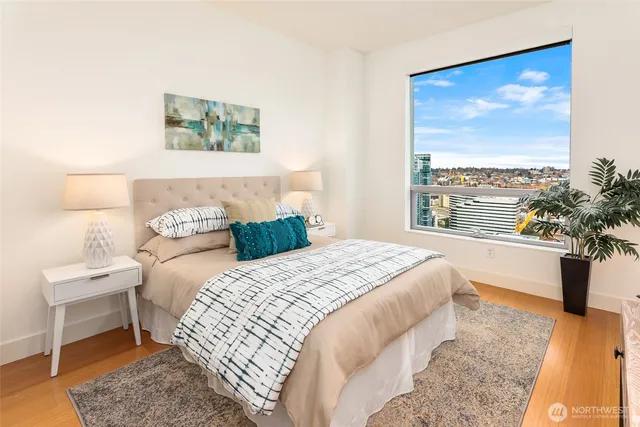 a bedroom with a bed and a large window