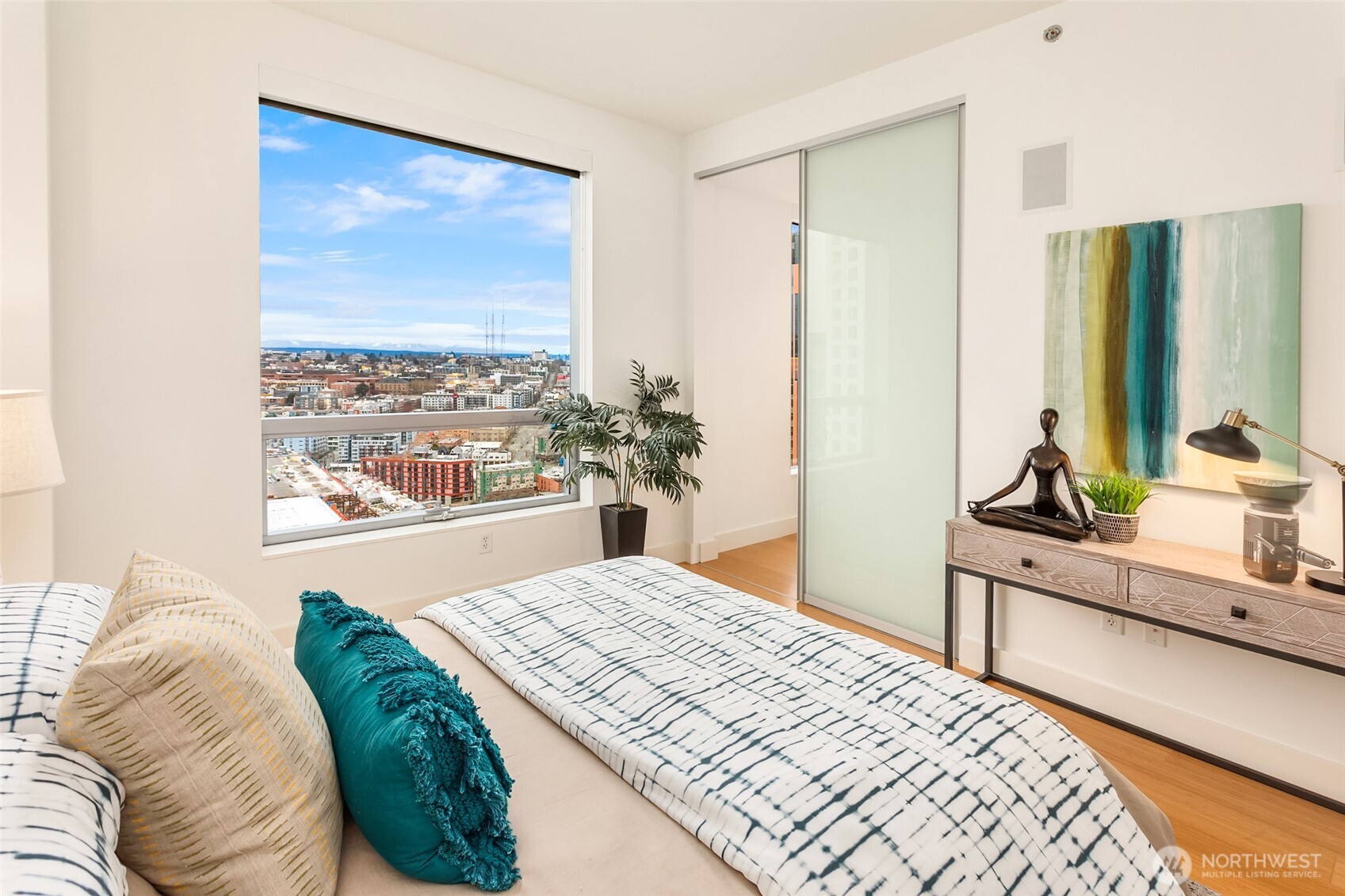 737 Olive Way, Unit 2905 Seattle, WA 98101 - Photo 22 of 38 a bedroom with a bed and a large window