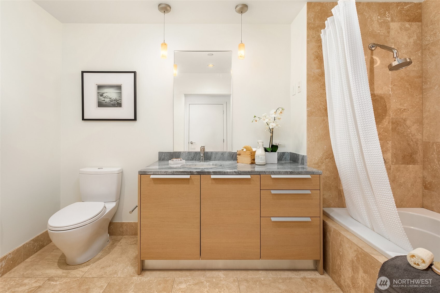 737 Olive Way, Unit 2905 Seattle, WA 98101 - Photo 23 of 38 a bathroom with a granite countertop sink toilet and a bathtub