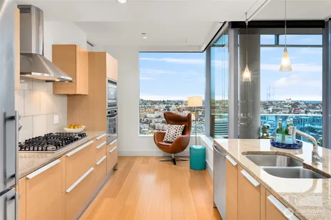 a kitchen with stainless steel appliances granite countertop a stove and a refrigerator