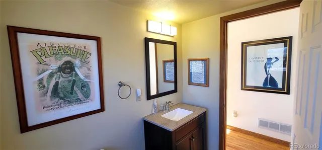 a bathroom with a toilet a sink and a mirror