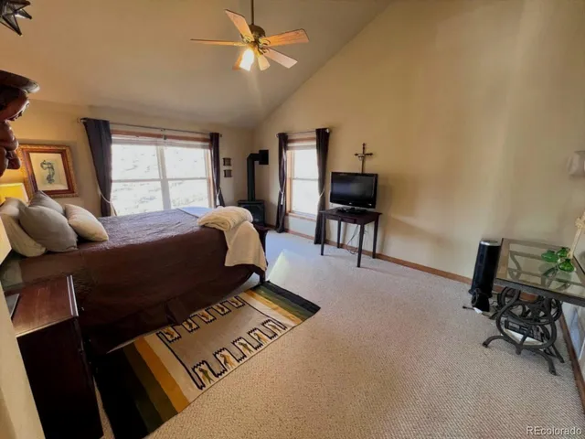 a bed room with a bed window and a chair