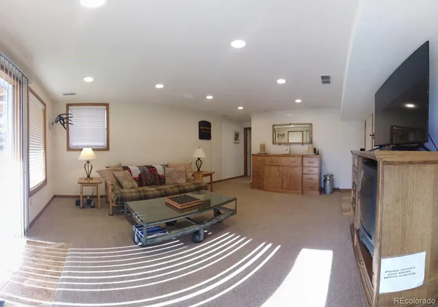 a living room with furniture and a table