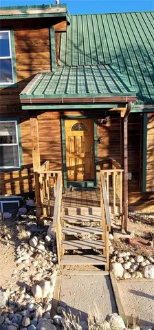a view of a patio with table and chairs a barbeque with wooden floor