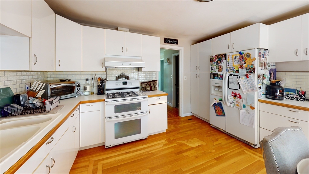 37 Centre Street Natick, MA 01760 - Photo 1 of 8 a kitchen with white cabinets and white appliances