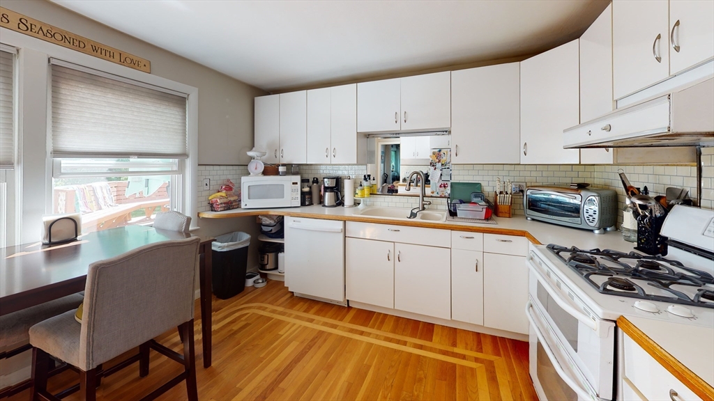 37 Centre Street Natick, MA 01760 - Photo 2 of 8 a kitchen with a sink appliances cabinets and a window