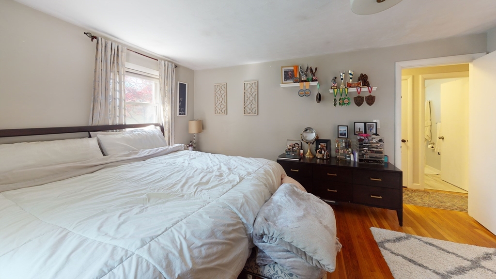 37 Centre Street Natick, MA 01760 - Photo 4 of 8 a bedroom with a bed and wooden floor