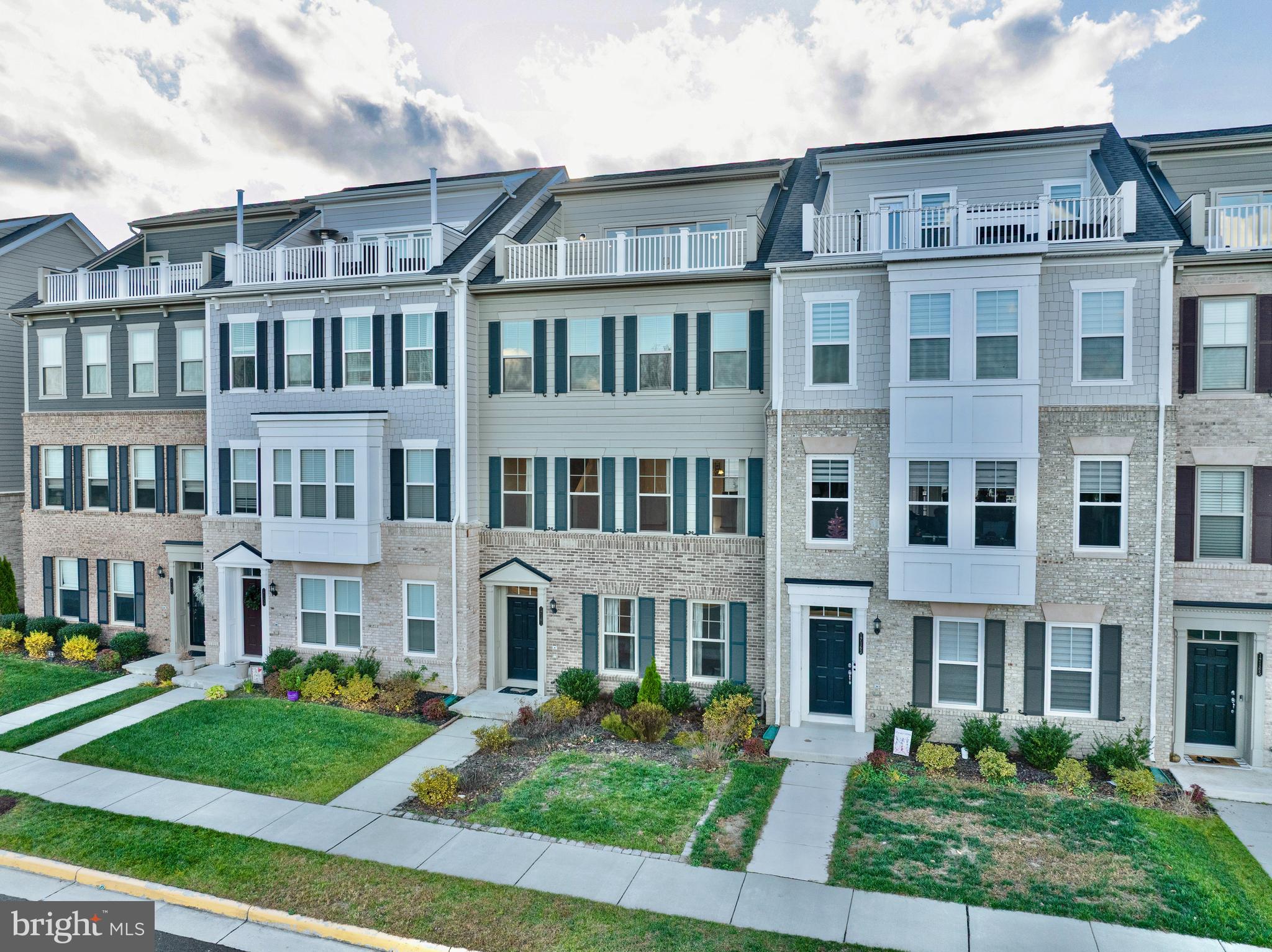 front view of a brick house with a yard