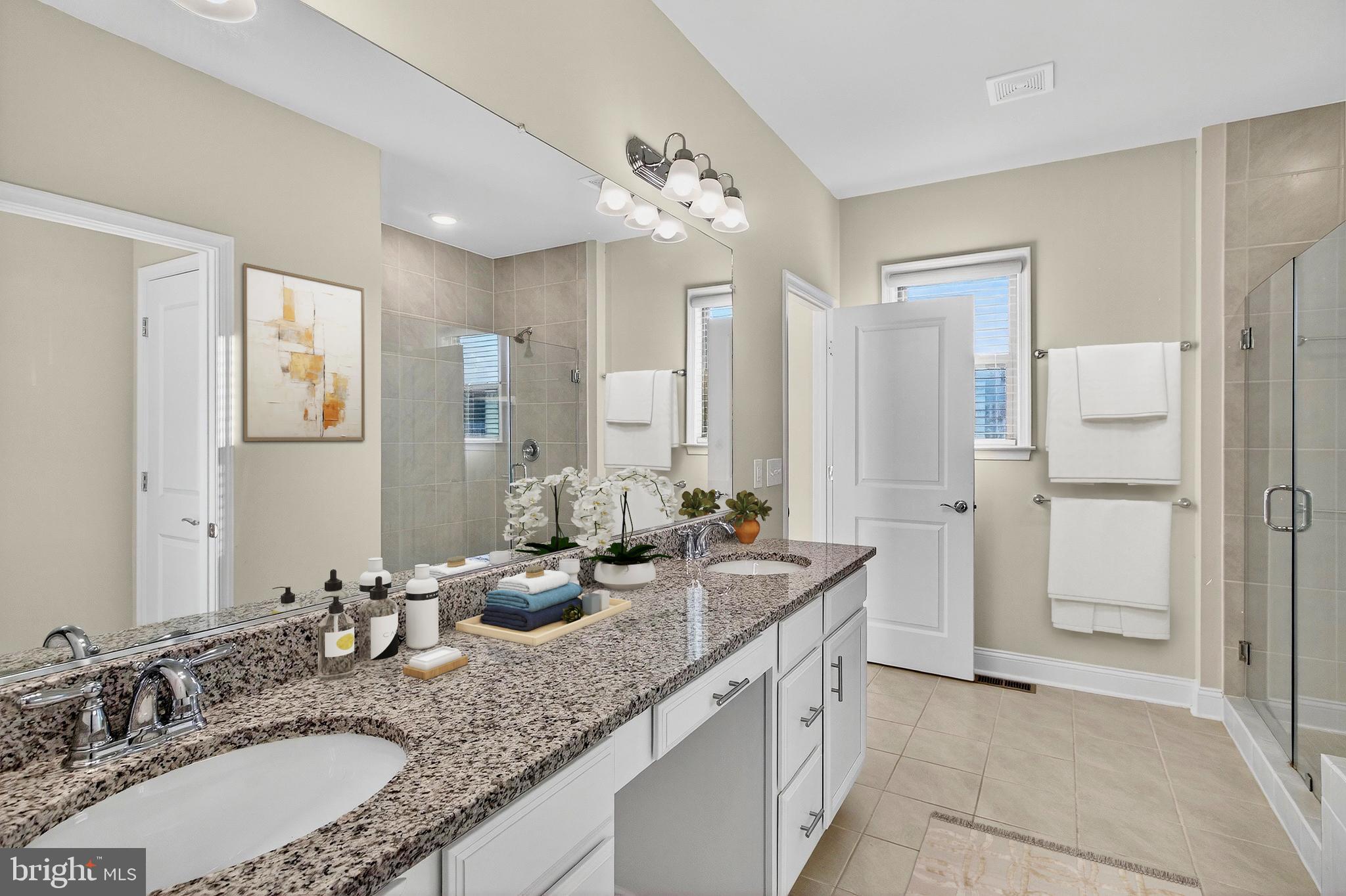17161 Branched Oak Road Dumfries, VA 22026 - Photo 15 of 28 a bathroom with double vanity sinks and a mirror