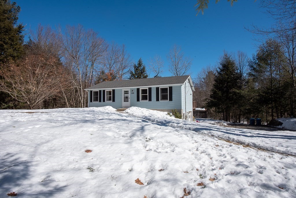 112 Barre Paxton Road Rutland, MA 01543 - Photo 1 of 36 a view of a house with snow on the road