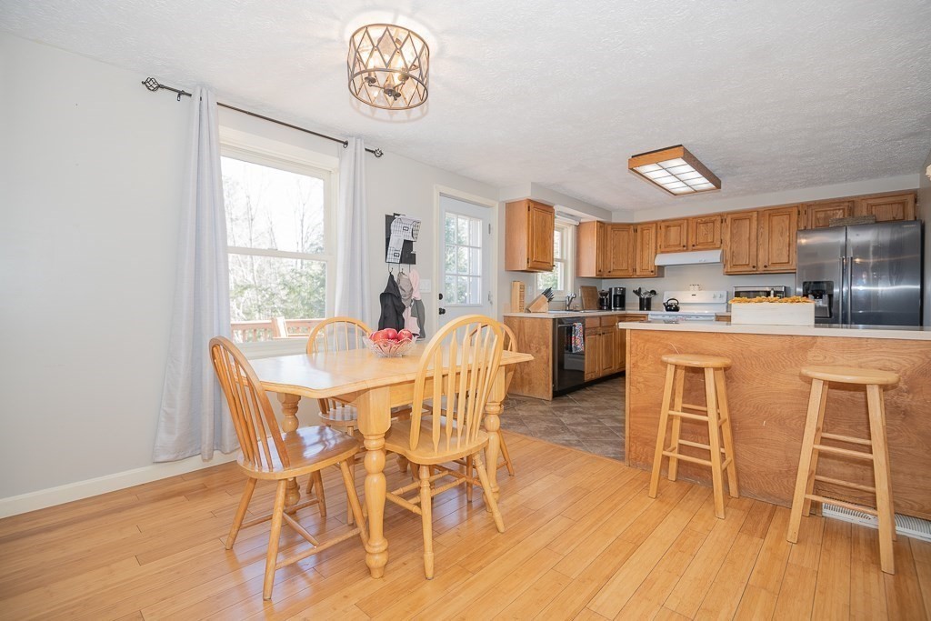 112 Barre Paxton Road Rutland, MA 01543 - Photo 11 of 36 a dining room with stainless steel appliances a table and chairs