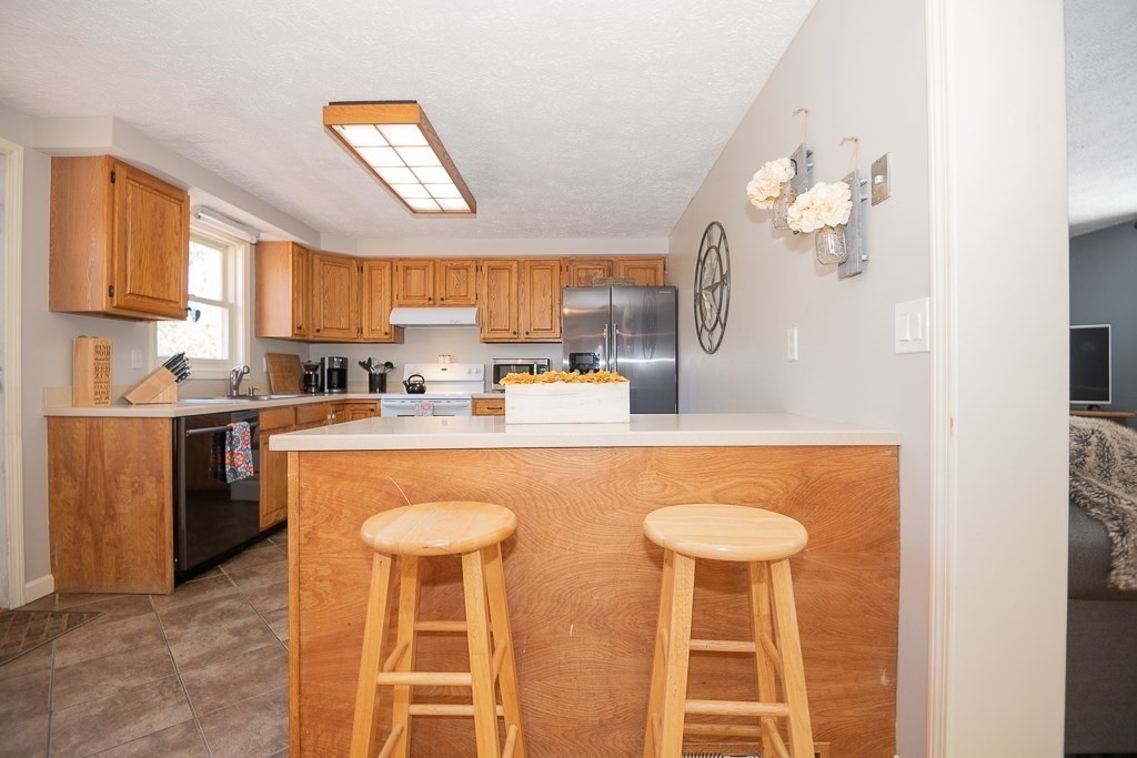 112 Barre Paxton Road Rutland, MA 01543 - Photo 12 of 36 a kitchen with stainless steel appliances granite countertop a sink a stove and a refrigerator