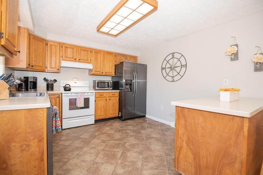 112 Barre Paxton Road Rutland, MA 01543 - Photo 13 of 36 a kitchen with stainless steel appliances cabinets and a large window