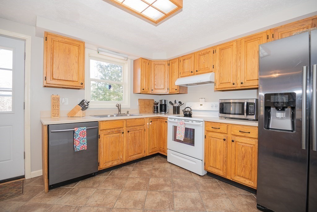 112 Barre Paxton Road Rutland, MA 01543 - Photo 14 of 36 a kitchen with stainless steel appliances granite countertop a stove sink and cabinets