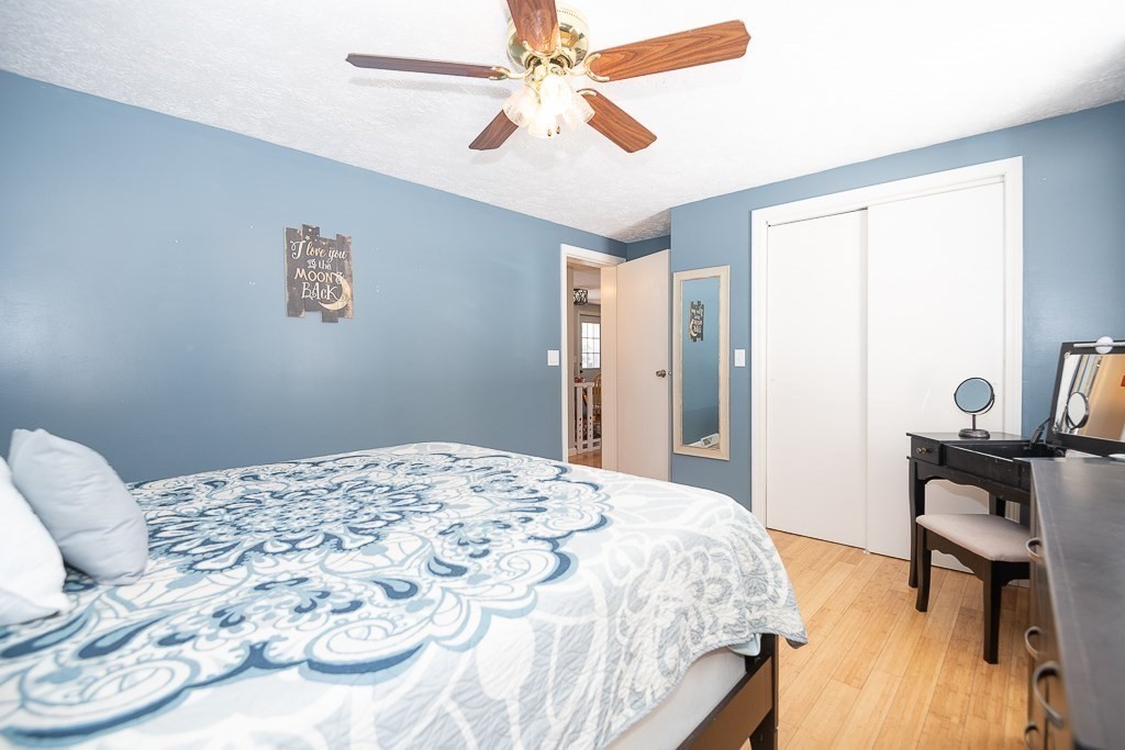 112 Barre Paxton Road Rutland, MA 01543 - Photo 20 of 36 a bedroom with a bed and a chandelier