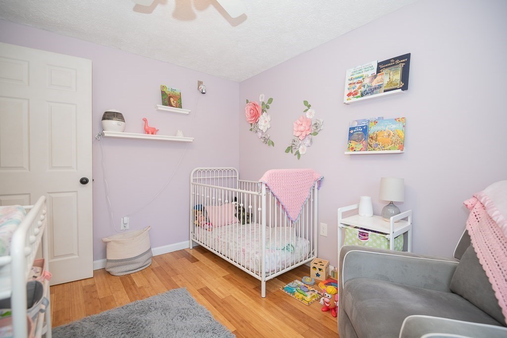 112 Barre Paxton Road Rutland, MA 01543 - Photo 23 of 36 a living room with furniture and a baby crib