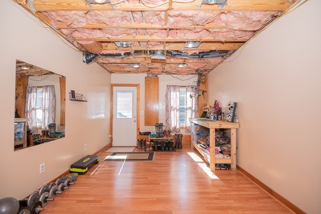 112 Barre Paxton Road Rutland, MA 01543 - Photo 29 of 36 a dining room with wooden floor and chandelier
