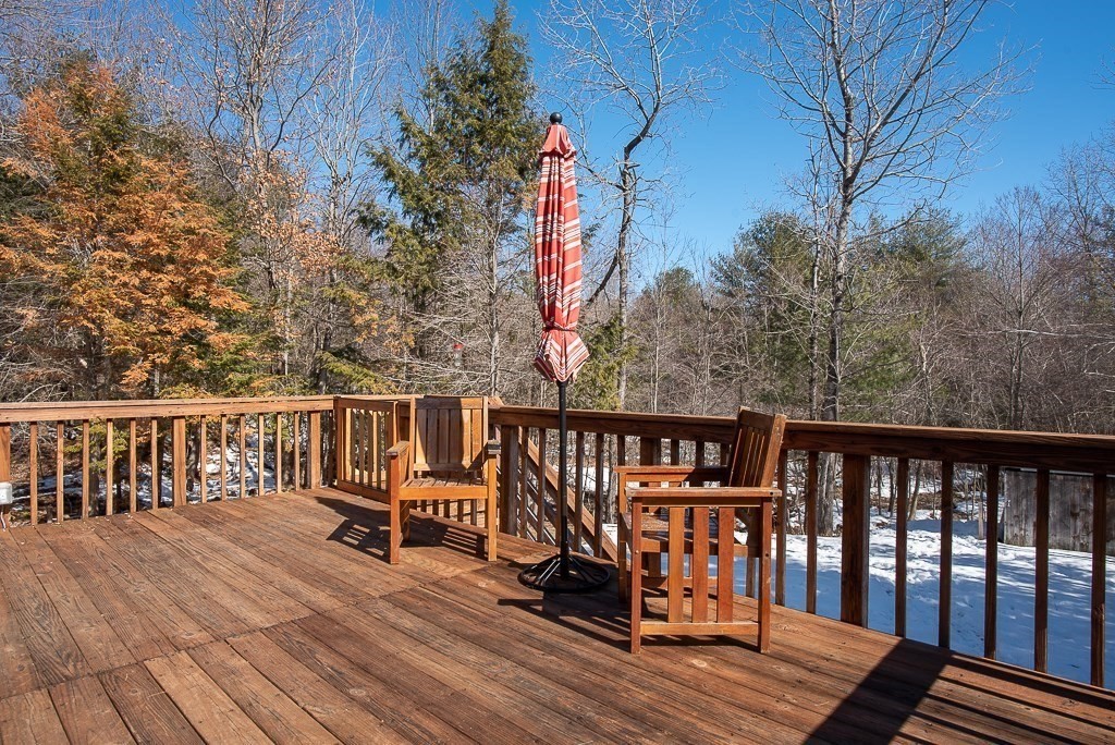112 Barre Paxton Road Rutland, MA 01543 - Photo 32 of 36 a balcony with wooden floor and wooden fence