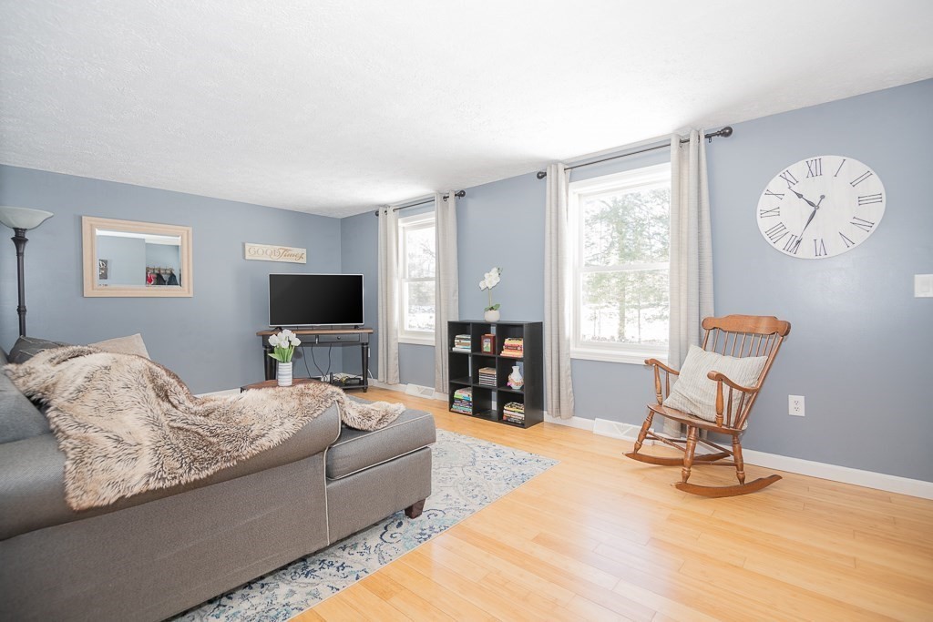 112 Barre Paxton Road Rutland, MA 01543 - Photo 4 of 36 a living room with furniture and a flat screen tv