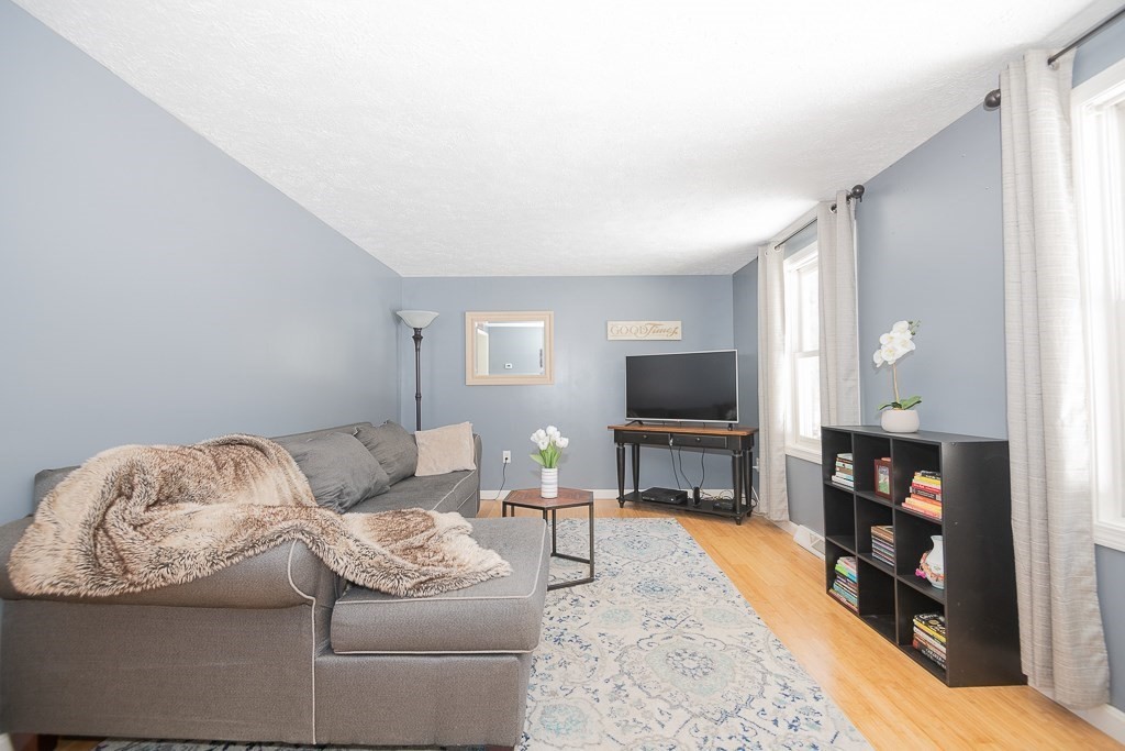 112 Barre Paxton Road Rutland, MA 01543 - Photo 5 of 36 a living room with furniture and a flat screen tv