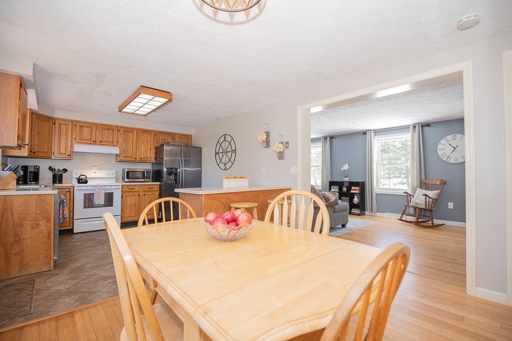 112 Barre Paxton Road Rutland, MA 01543 - Photo 9 of 36 a living room with furniture and a kitchen view