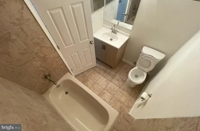 a bathroom with a sink mirror and toilet