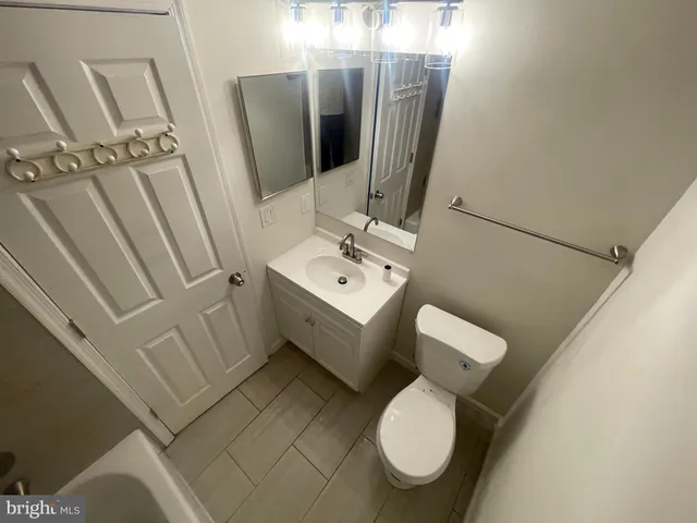 a bathroom with a tub a sink and a shower
