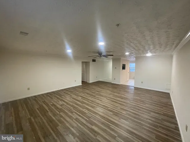 an empty room with wooden floor